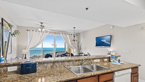 A kitchen with granite countertops, a dishwasher, and a view of the ocean. - ☀️Pools-18th Fl Gulf Views-1BR+Bunks Ariel Dunes II 1805☀️ (Destin)