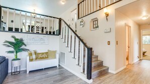 A staircase with a white railing and a 'welcome' sign, a white bench with 'thankful' pillows, and a potted plant. - Pet-Friendly Jackson Wine Country Home w/ Pool! (Jackson)