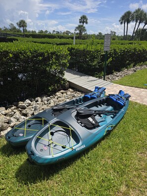 A kayak with a blue and black color scheme, a wooden dock, and a sign indicating 'Sunbow Bay Facilities For Residents Only.' - Great Island Getaway! (Holmes Beach)