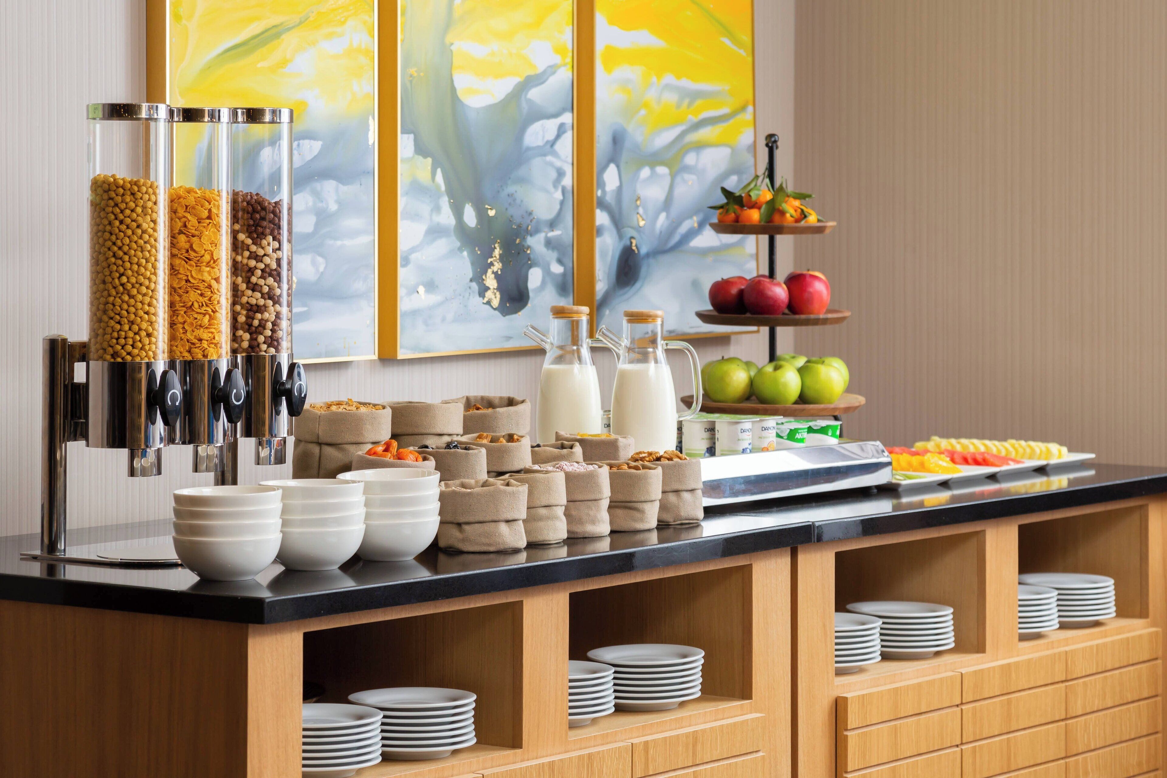 A buffet setup with various food items and containers.