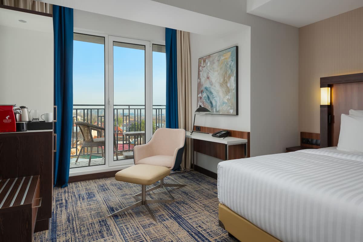 superior room, 1 king bed, balcony, city view | minibar, in-room safe, desk, laptop workspace