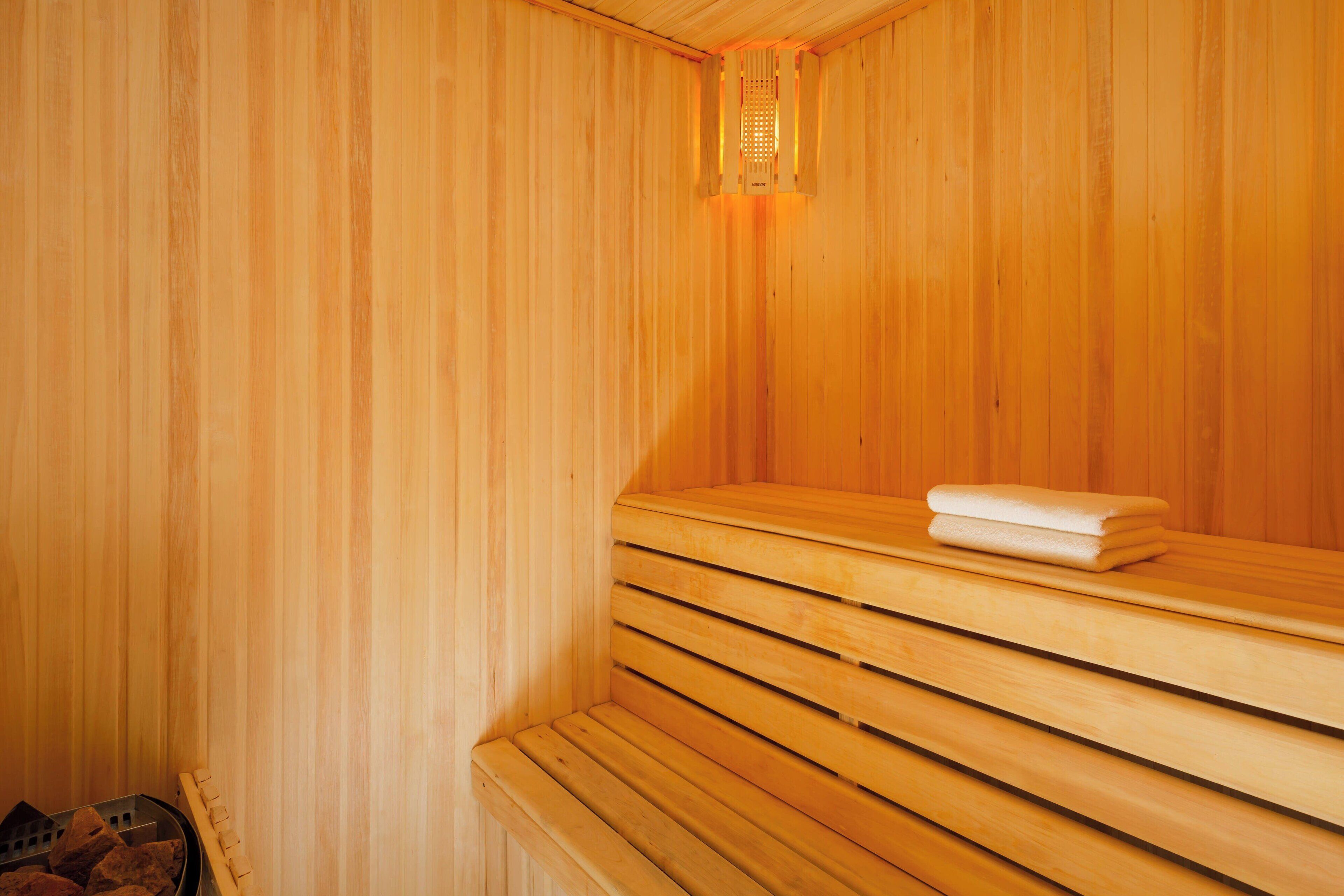 A sauna with wooden benches and a towel on one.