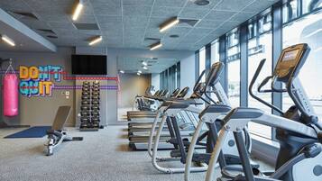 A gym with treadmills, a punching bag, and a motivational wall.