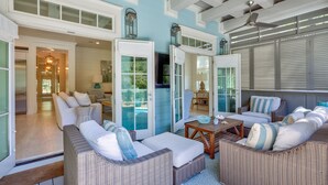 A spacious outdoor living area with wicker furniture, a pool, and a covered patio. - WaterColor - 4+BR, Private Heated Pool, 6 Seat LSV - 6 Bikes (Santa Rosa Beach)