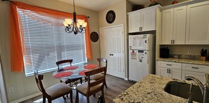 Enjoy meals in this well-equipped kitchen with a dining table and comfortable seating for four.
