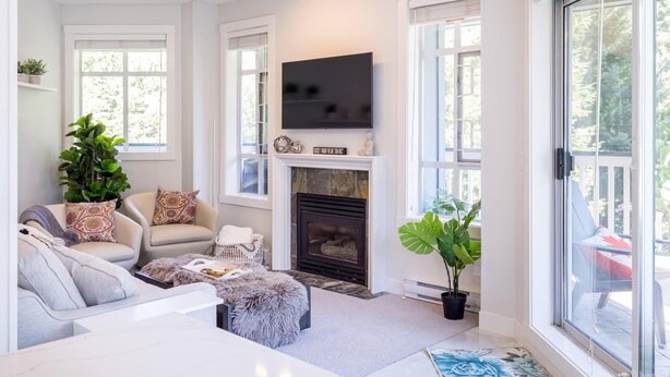 A modern living room with a fireplace, comfortable seating, and large windows. - Panoramic Views From This Gorgeous 2 Bed Property - Village Location (Whistler)