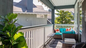 A covered porch with a wicker sofa, a bench, and a table. - Panoramic Views From This Gorgeous 2 Bed Property - Village Location (Whistler)