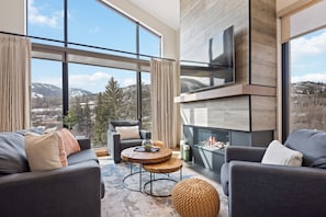 Apartment, Multiple Beds, Mountainside (Two-Bedroom Apartment) | Living room | 50-inch Smart TV with satellite channels, TV, fireplace - Riverfront Lodge (Avon)