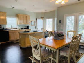 Enjoy cooking in this well-equipped kitchen with a central island, oven, and coffee maker.
