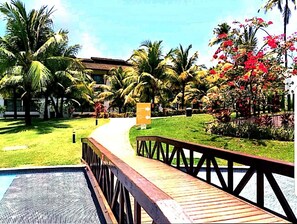 Relax on the resort's deck, surrounded by lush tropical vegetation and a tranquil atmosphere.