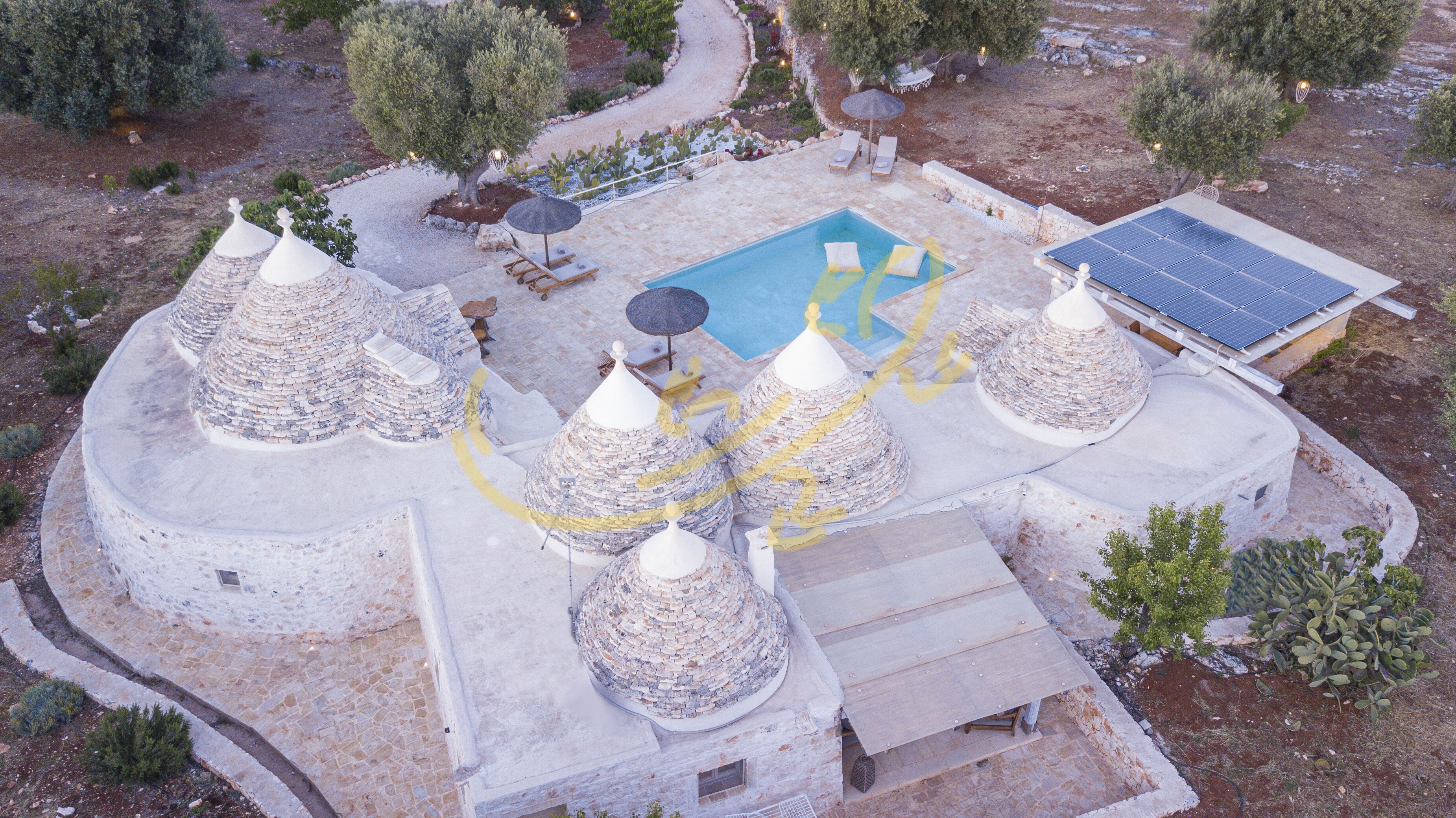 A rooftop with multiple conical structures, a swimming pool, and solar panels.
