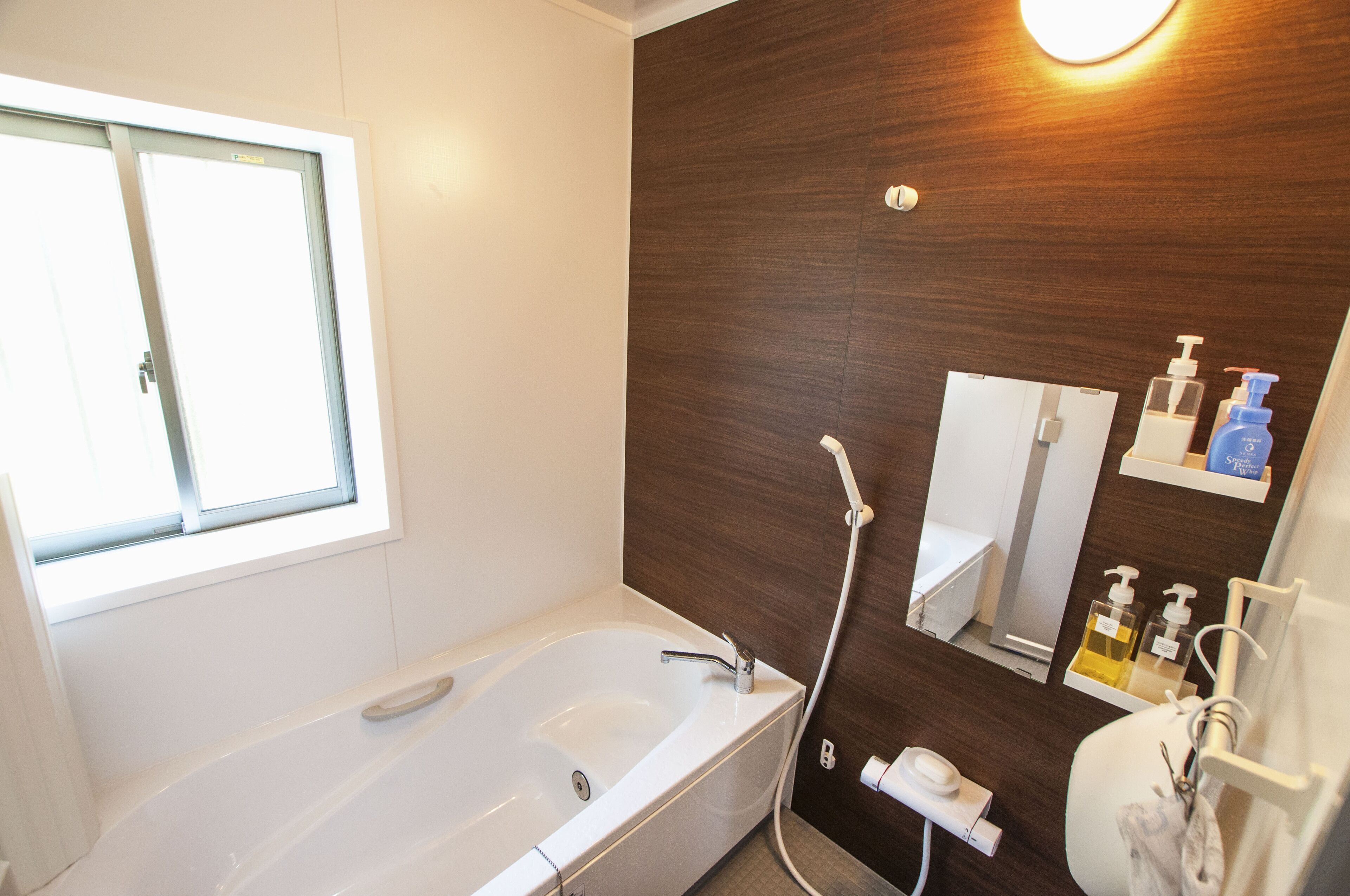 A modern bathroom with a bathtub, a shower, a toilet, and a sink.