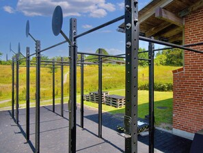 A metal gym equipment setup outdoors with a brick building in the background. - 6 Person Holiday Park Home in Gilleleje (Gilleleje)