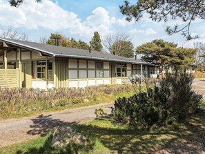 A row of single-story buildings with a simple, functional design, featuring large windows and a flat roof. - 6 Person Holiday Park Home in Gilleleje (Gilleleje)