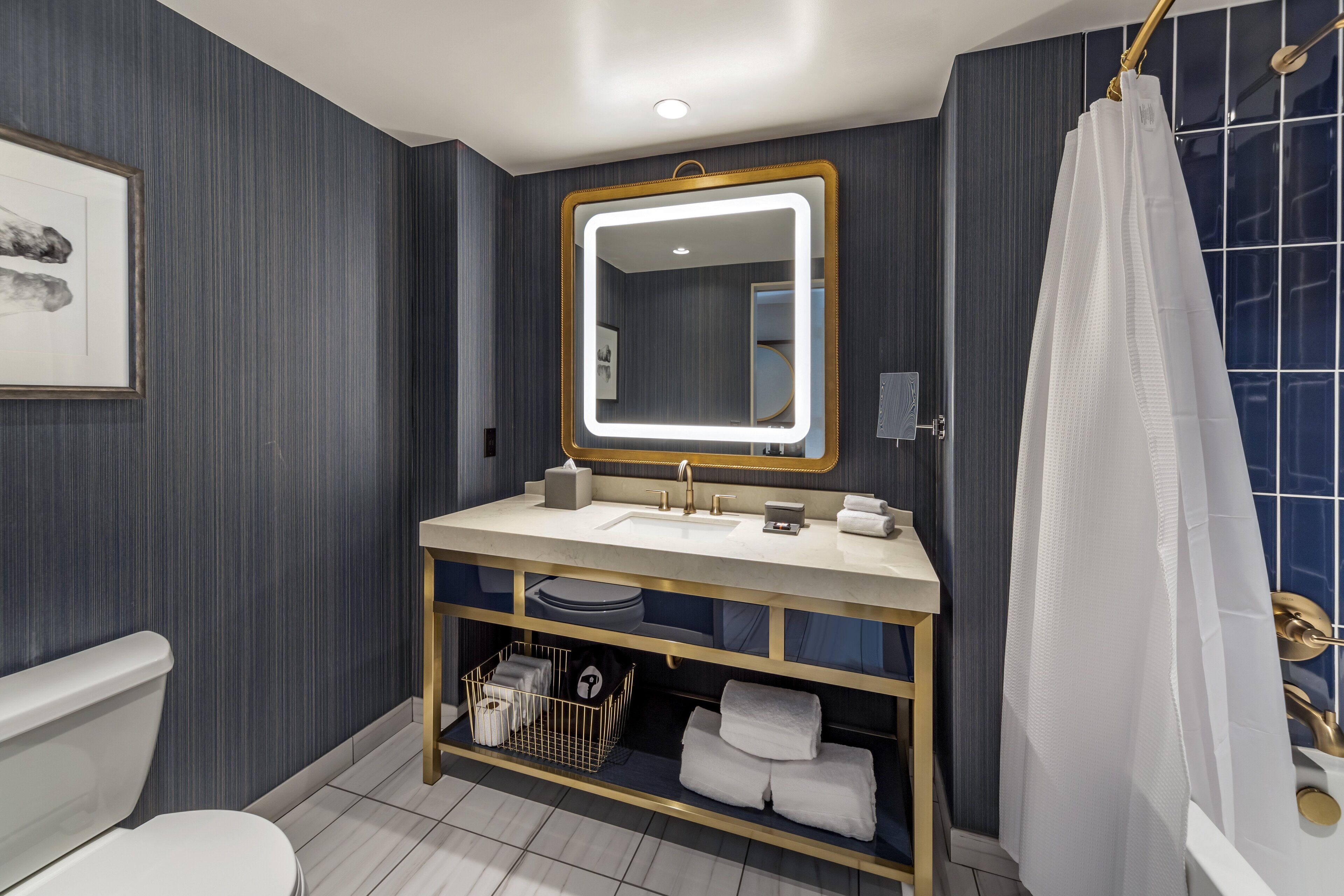A modern bathroom with a vanity, sink, and mirror.