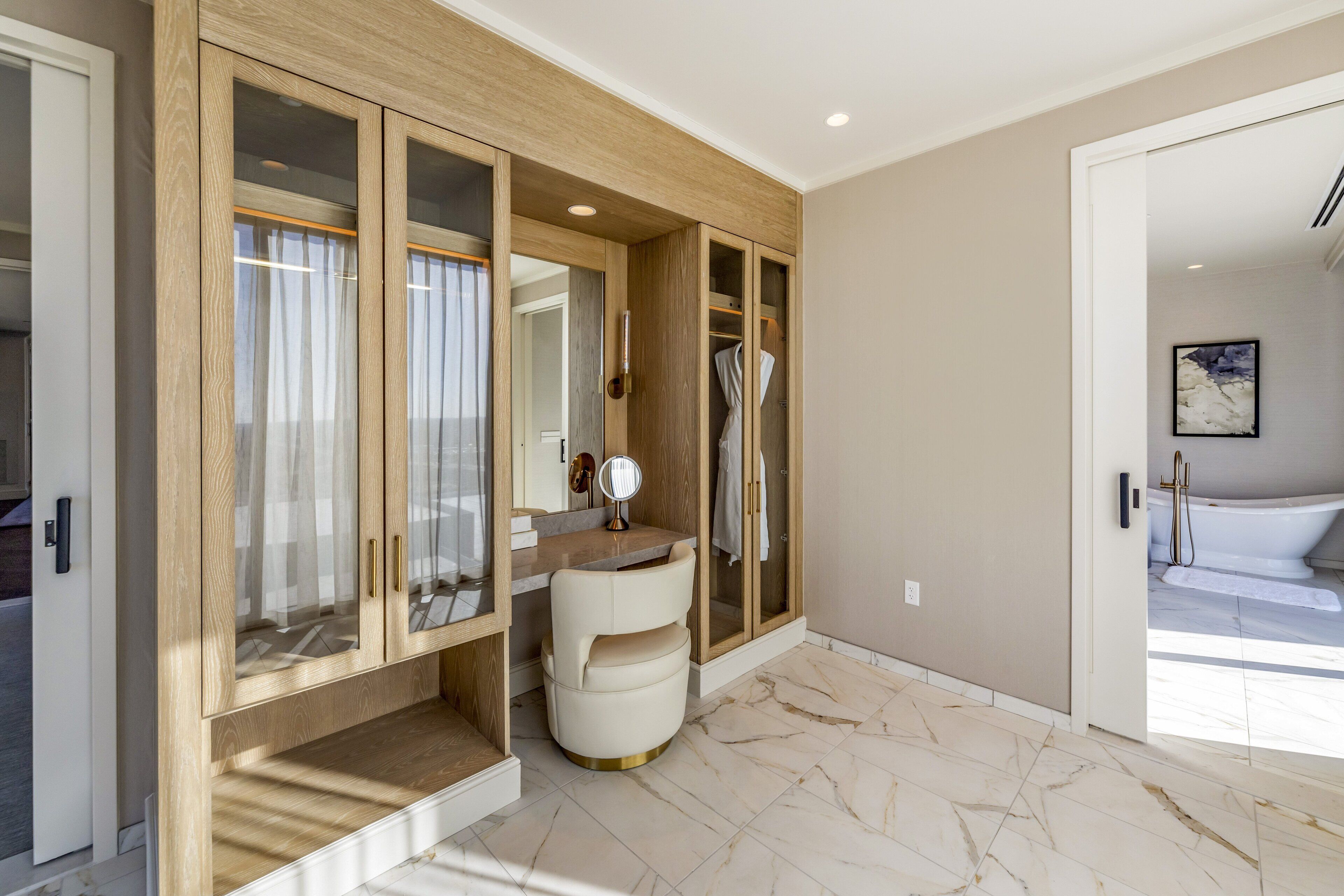 A modern bathroom with a vanity, a mirror, and a shower area.