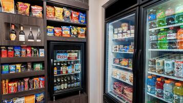 A vending machine stocked with snacks, beverages, and alcoholic drinks.