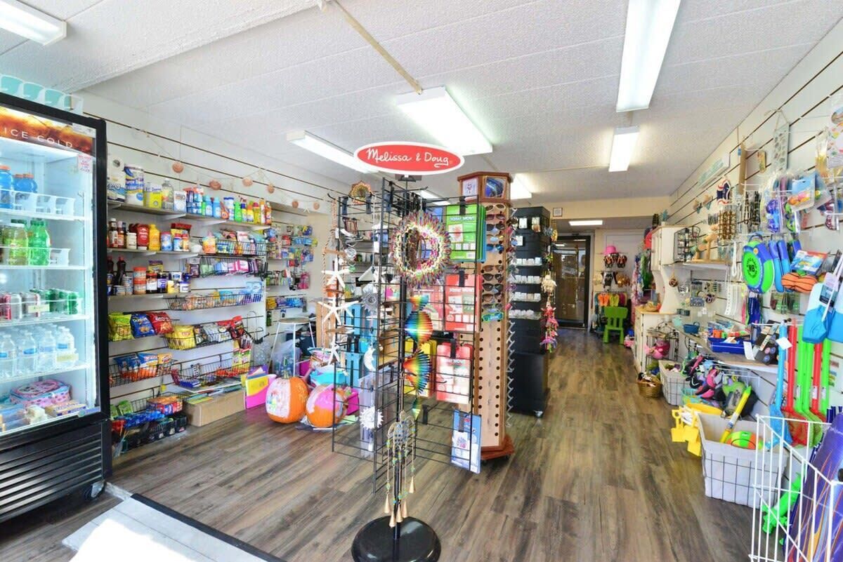 Una tienda con estantes llenos de diversos productos, una exhibición de artículos coloridos y un letrero que dice "Melissa & Doug".