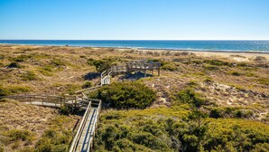 A wooden boardwalk leading to a beach with dunes and sparse vegetation. - LABOR DAY 2 NGT MINIMUM  SPECIAL! GORGEOUS CONDO WITH BEAUTIFUL OCEAN VIEWS! (Atlantic Beach)