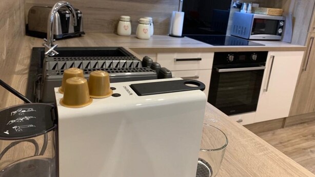 A compact kitchen with a built-in coffee maker, a toaster, and a microwave. - Impeccable 2-bed Apartment in Birmingham (Birmingham)