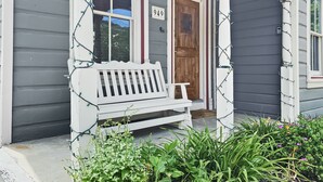 A house with a porch, a bench, and a wooden door. - Brekke's Basecamp 3 Bedroom Home by RedAwning (Park City)