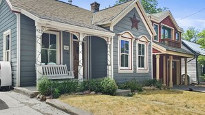 A two-story house with a porch, a mailbox, and a front yard with dry grass. - Brekke's Basecamp 3 Bedroom Home by RedAwning (Park City)