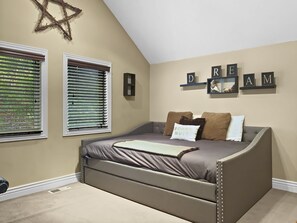 A bedroom with a bed, two windows with blinds, a Star of David decoration, and a wall with 'DREAM' spelled out in letters. - Brekke's Basecamp 3 Bedroom Home by RedAwning (Park City)