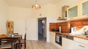 A modern kitchen with wooden cabinets, a built-in oven, and a coffee maker. - *NEW* Central (5min to city center) *Netflix & Amazon Prime* Kleiststrasse 4 MD (Sachsen-Anhalt - Magdeburg)