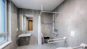Une salle de bain moderne équipée d’une douche, de toilettes et d’un lavabo.