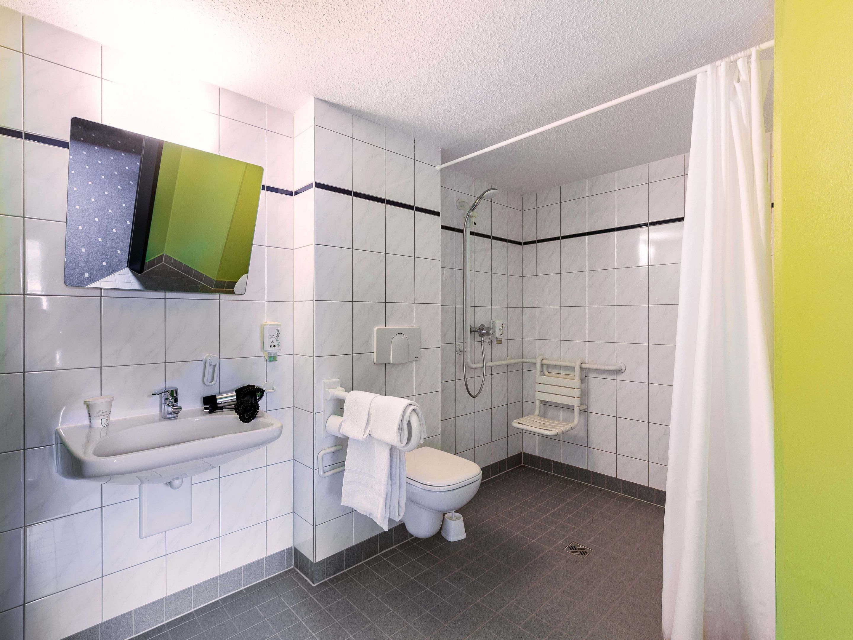 Ein modernes Badezimmer mit Toilette, Waschbecken und Dusche.