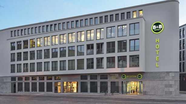 A modern hotel building with a reception area and multiple windows. - B&B HOTEL Halle (Saale) (Halle (Saale))