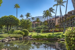 A resort with a pool, palm trees, and a mountain in the background. - Kamaole Sands Remodeled 1 Bed 2 bathroom, Split AC, king bed (Kihei)