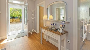 A modern bathroom with a large mirror, a vanity with a lamp, and a shower area. - Lower Canterbury House (Gattonside, near Melrose)