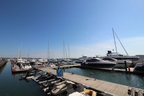 A marina with multiple boats docked at wooden piers.