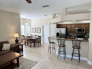 Enjoy cooking and dining in this well-designed kitchen and dining area, featuring a refrigerator, microwave, and double oven.