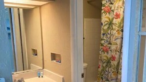 A bathroom with a sink, toilet, and shower curtain. - Cute Studio!  Remodeled!  Direct Ocean Front! Pirates Cove 6th Floor (Daytona Beach)