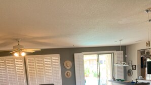 A spacious living room with a sofa set, a coffee table, and a small side table. There is a sign that reads "Welcome, Come In and STAY a while." - It’s AZ Time...Relax in a private heated pool, Golf, Spring Training, Hiking! (Surprise)