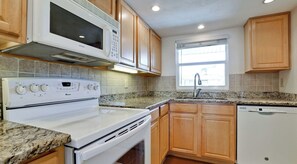 Enjoy cooking in this well-equipped kitchen with a microwave, stove, and dishwasher.