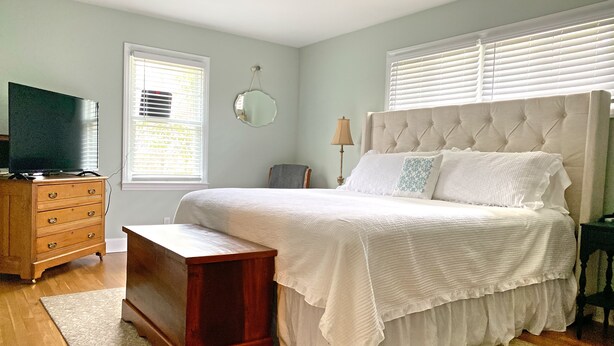 A bedroom with a bed, dresser, TV, and a window with blinds. - Quiet home in the Kernersville near Winston Salem, Greensboro, High Point (Kernersville)