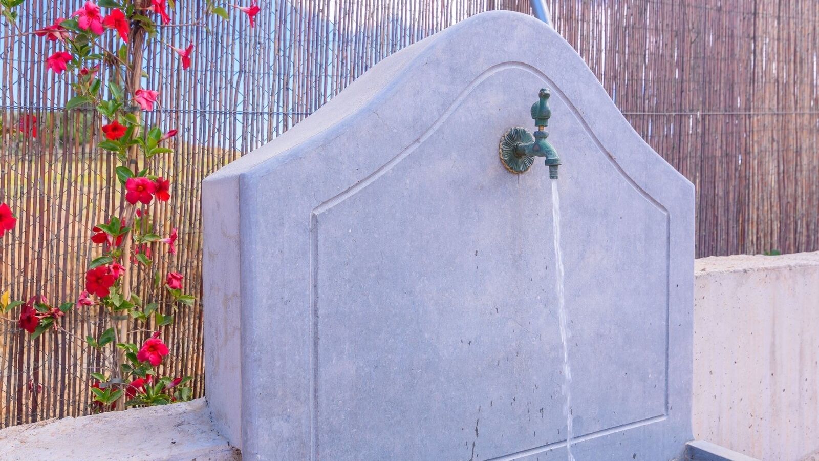 A concrete structure with a water spout.
