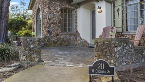 A stone house with a stone facade, a large window, and a porch. - Emmie's | Great Location (Fredericksburg)