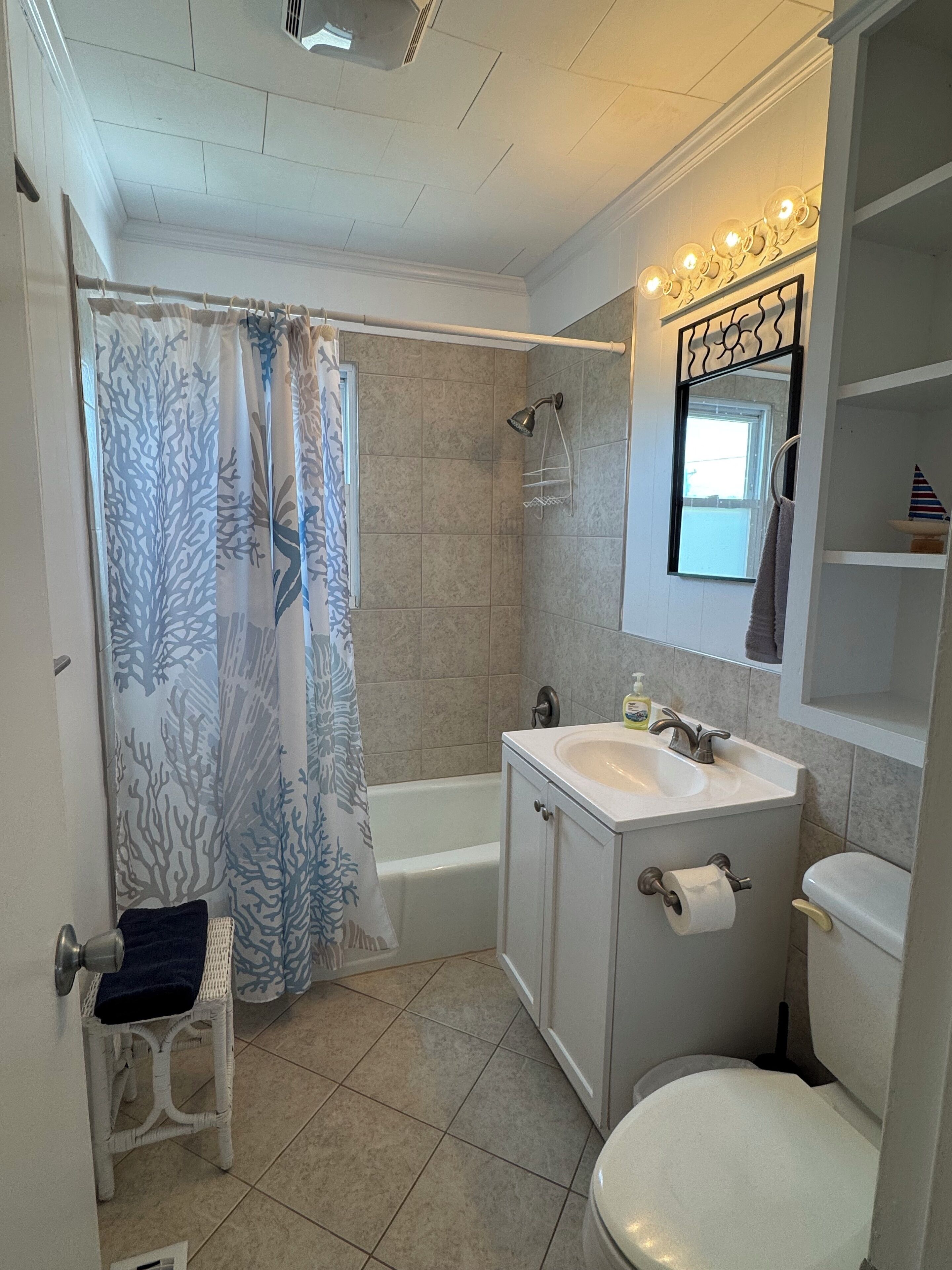 A bathroom with a bathtub, a sink, and a toilet.