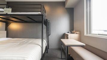 A bunk bed room with a desk and a bench.