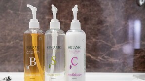Three bottles of organic shampoo, conditioner, and body soap on a white surface. - Super Hotel Kanku Kumatoriekimae (Kumatori)