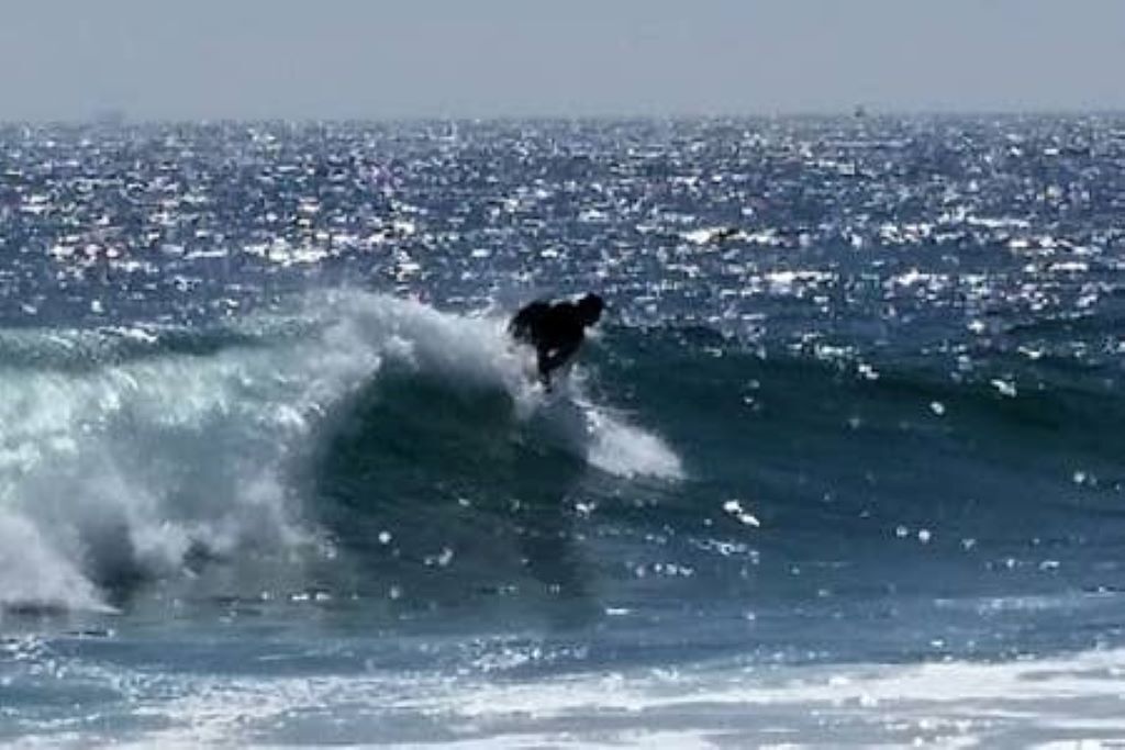 A person surfing a wave in the ocean.