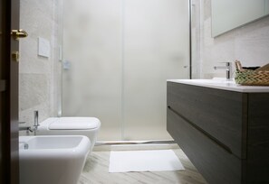 Regadera, bidet, toallas, papel de baño