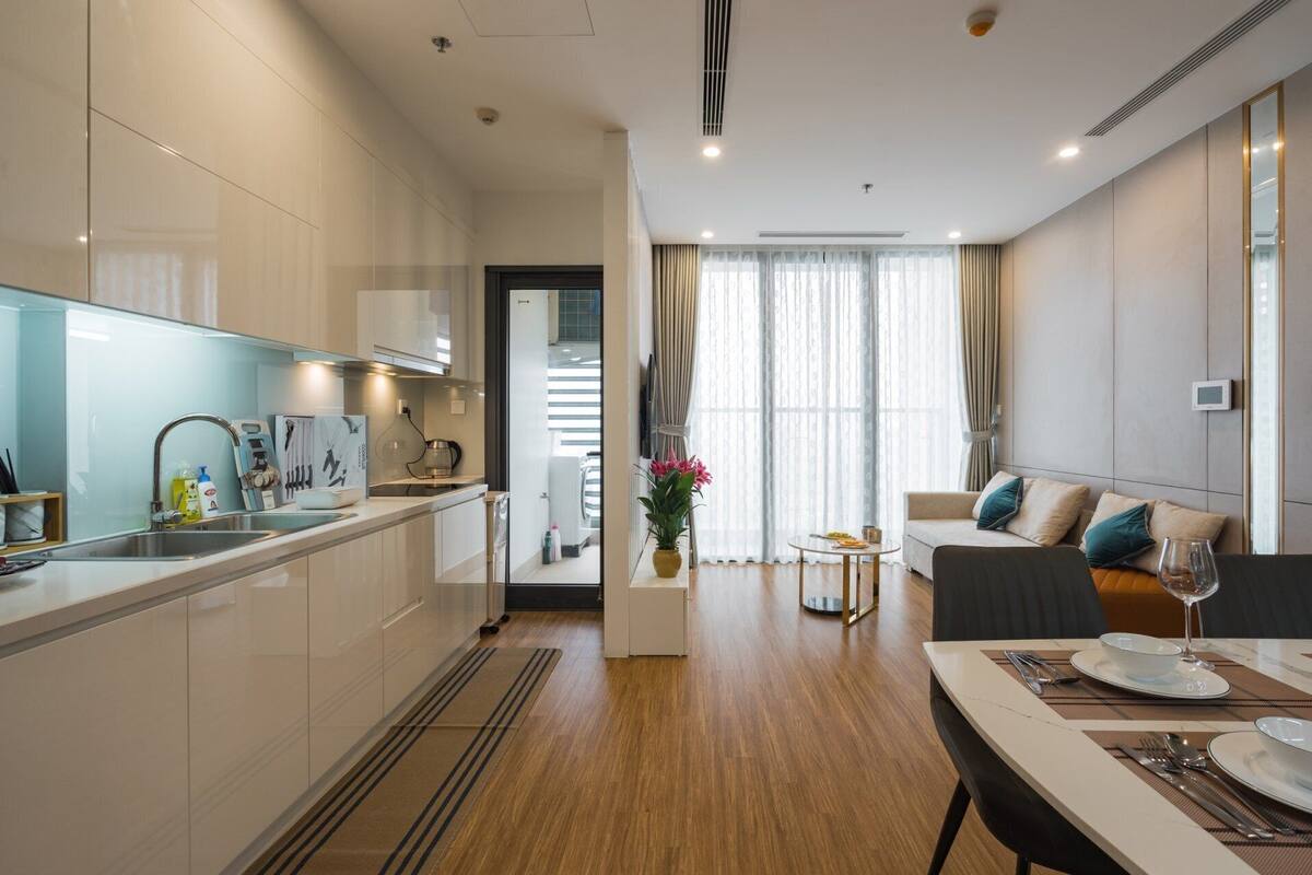 A modern apartment with a kitchen, dining area, and living room.