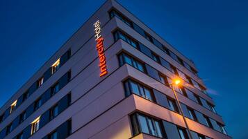 A modern hotel building with a prominent "Hotel" sign on the facade.