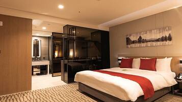 A hotel room with a large bed, a desk with a chair, a mirror, and a painting on the wall.