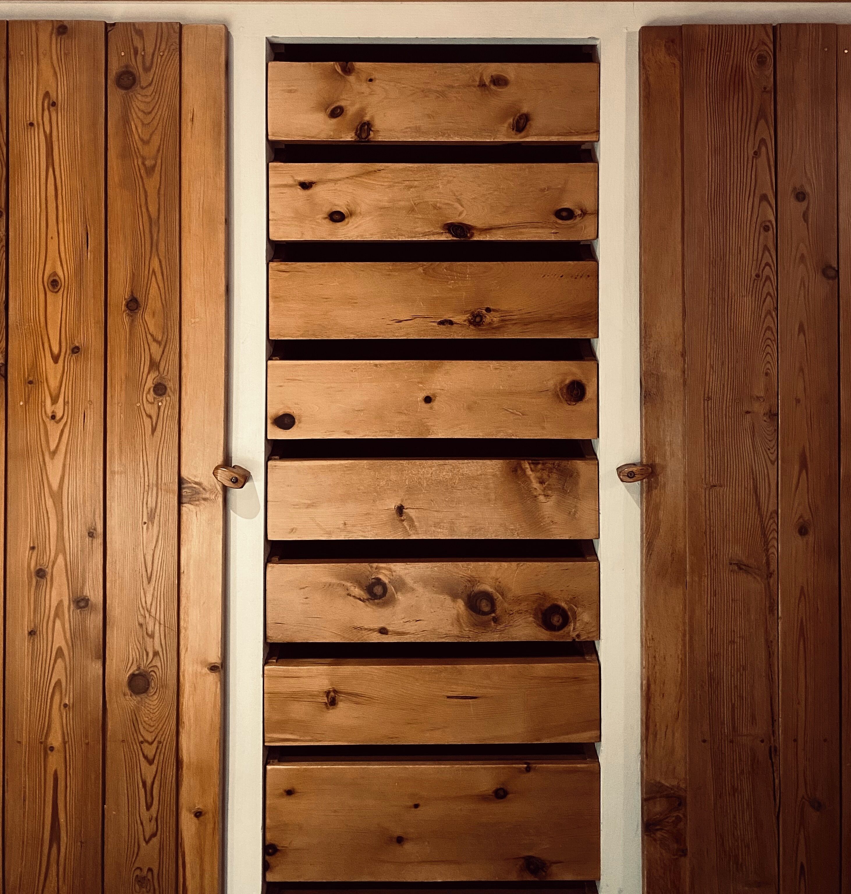 A wooden sliding door with multiple horizontal slats.